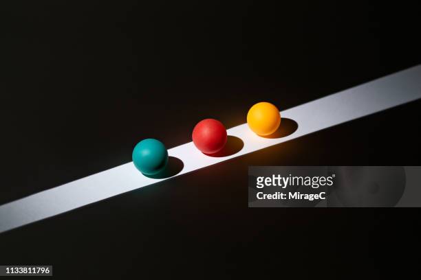 colorful spheres on light stripe - championship round three stock-fotos und bilder