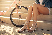 Beautiful young woman taking a break of riding bicycle