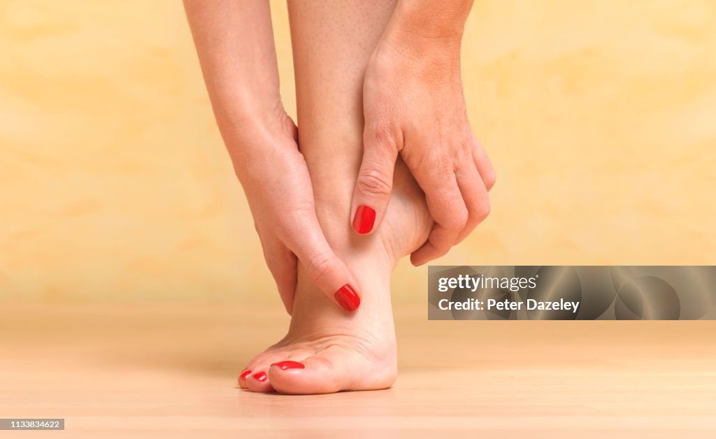 Massaging sore foot