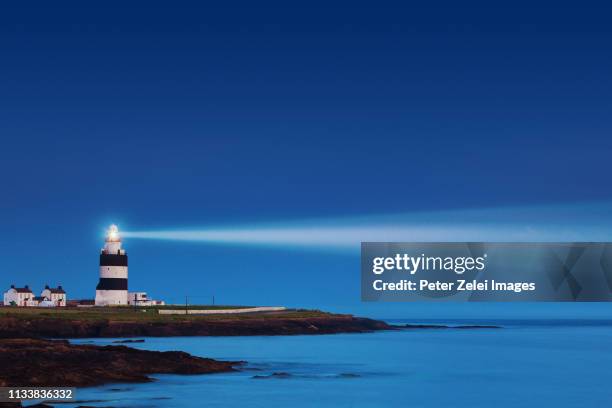 lighthouse in the night - lighthouse ストックフォトと画像