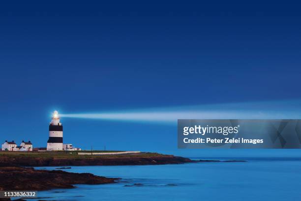 lighthouse in the night - beacon stock pictures, royalty-free photos & images