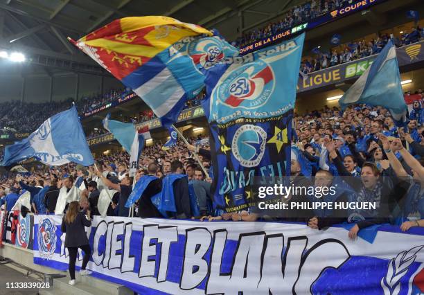 Strasbourg's supporters wave flags ahead of the French League Cup final football match Guingamp vs Strasbourg, on March 30, 2019 at the Pierre-Mauroy...