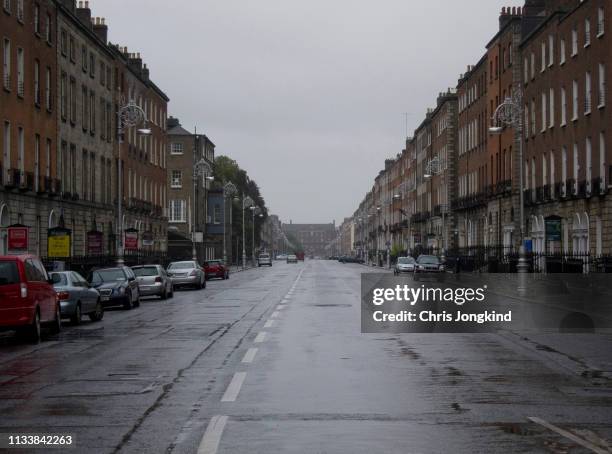 wide city street with parked cars and residential buildings over retail - dublin street stock pictures, royalty-free photos & images