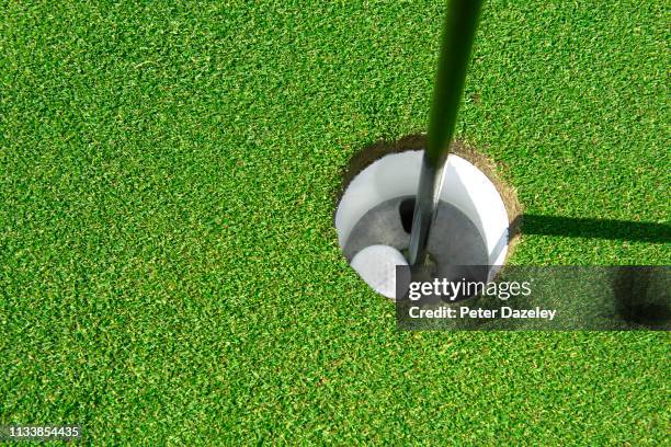 golf ball in hole - ace stock-fotos und bilder