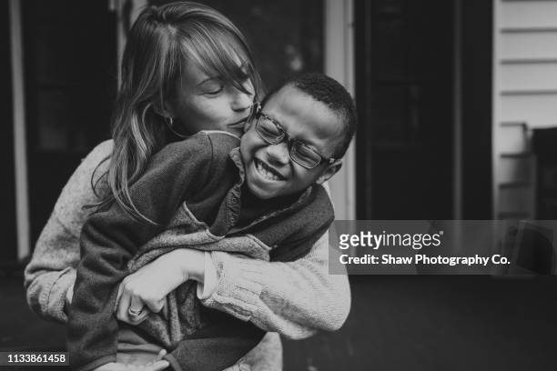 caucasian mother and adoptive african american son - blanco y negro fotografías e imágenes de stock