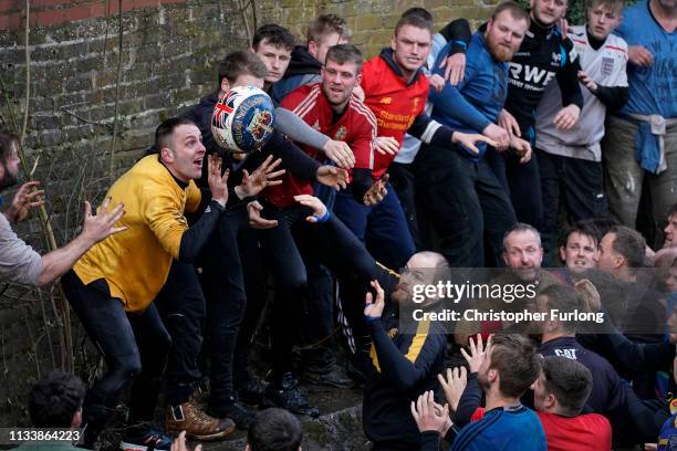 Rival teams the 'Up'ards and Down'ards' battle for the ball during the annual Ashbourne Royal Shrovetide 'no rules' football match on March 05, 2019...