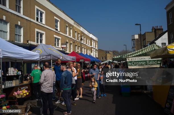 View of Broadway Market, London on March 30, 2019. London Fields is a park in Hackney, East London. The park's history is recorded as early as the...