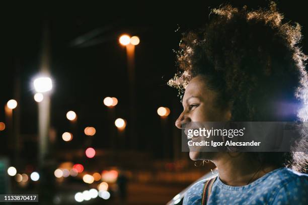 happy woman on the street at night - rio de janeiro street stock pictures, royalty-free photos & images