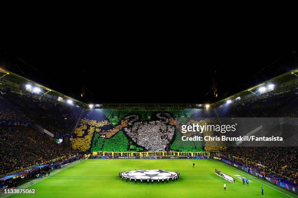 The Borussia Dortmund fans hold a banner to remember their UEFA Champions League win of 1997 before the UEFA Champions League Round of 16 Second Leg...