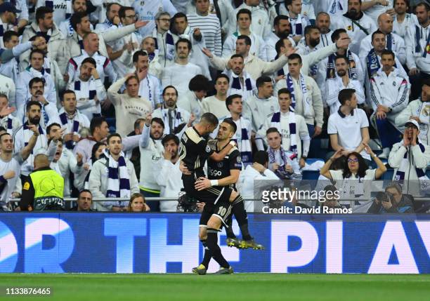 Hakim Ziyech of Ajax celebrates after scoring his team's first goal with Dusan Tadic in front of Real Madrid fans during the UEFA Champions League...