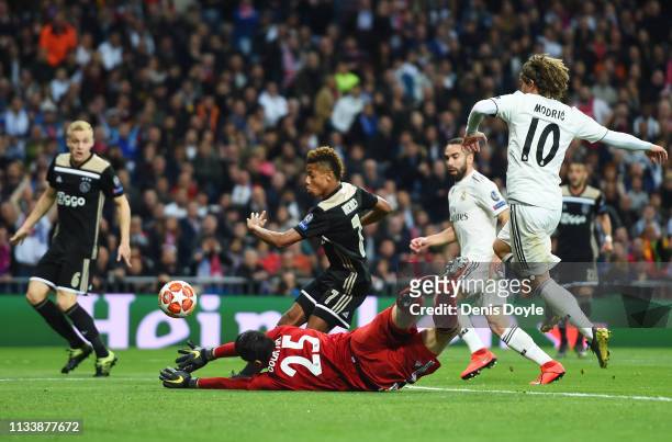 David Neres of Ajax scores his team's second goal past Thibaut Courtois of Real Madrid during the UEFA Champions League Round of 16 Second Leg match...