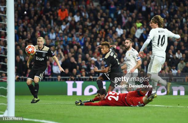 David Neres of Ajax scores his team's second goal past Thibaut Courtois of Real Madrid during the UEFA Champions League Round of 16 Second Leg match...