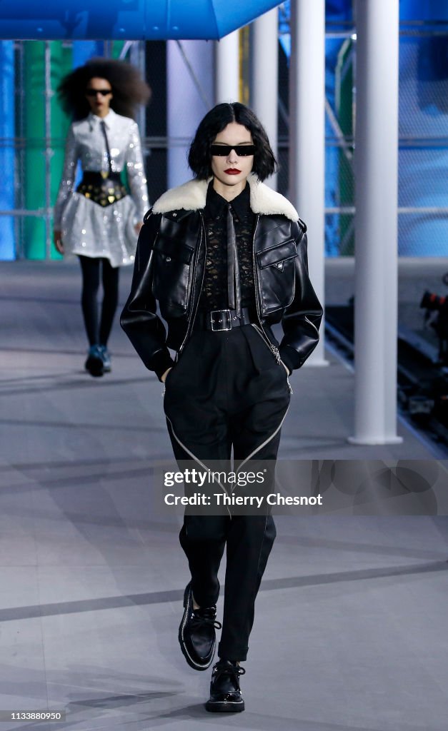 A model walks the runway during the Louis Vuitton show as part of the ...