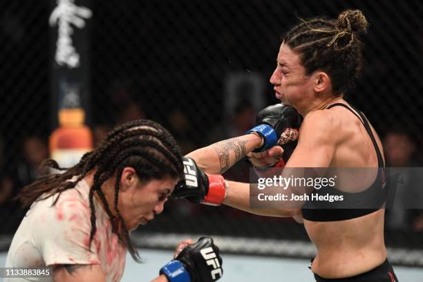 Jessica Aguilar punches Marina Rodriguez of Brazil in their women's strawweight bout during the UFC Fight Night event at Wells Fargo Center on March...