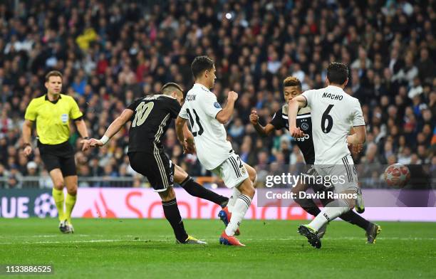 Dusan Tadic of Ajax scores his team's third goal during the UEFA Champions League Round of 16 Second Leg match between Real Madrid and Ajax at...