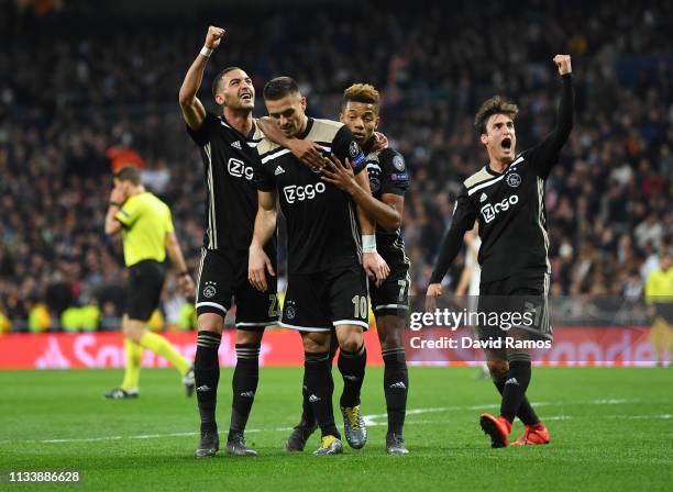 Dusan Tadic of Ajax celebrates as he scores his team's third goal with team mates during the UEFA Champions League Round of 16 Second Leg match...