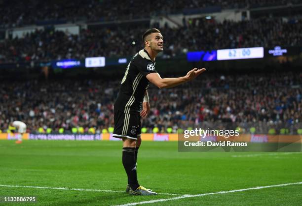 Dusan Tadic of Ajax celebrates as he scores his team's third goal during the UEFA Champions League Round of 16 Second Leg match between Real Madrid...