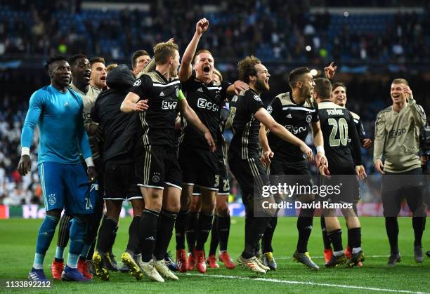 Ajax players celebrate victory after the UEFA Champions League Round of 16 Second Leg match between Real Madrid and Ajax at Bernabeu on March 05,...