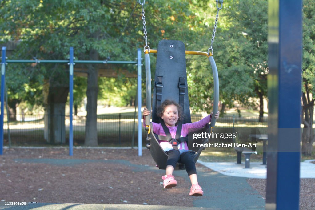 Young girl having fun on a flying fox swing