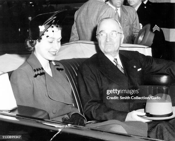 American President Harry Truman and Elizabeth II, sitting next to each other in the back of the Lincoln Cosmopolitan Presidential state car, with the...