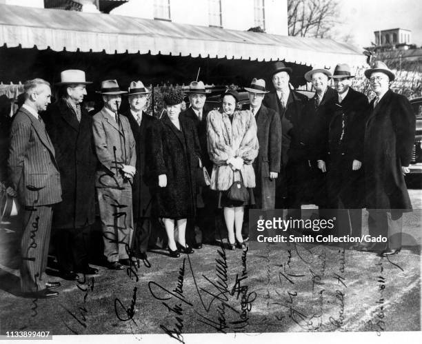 American President Harry Truman poses with his family and Cabinet members, outdoors, in full-length view, as they prepare to leave for the Capitol,...