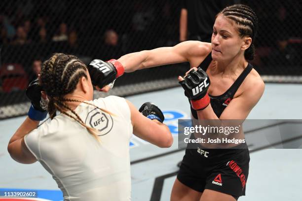 Karolina Kowalkiewicz of Poland punches Michelle Waterson in their women's strawweight bout during the UFC Fight Night Event event at Wells Fargo...