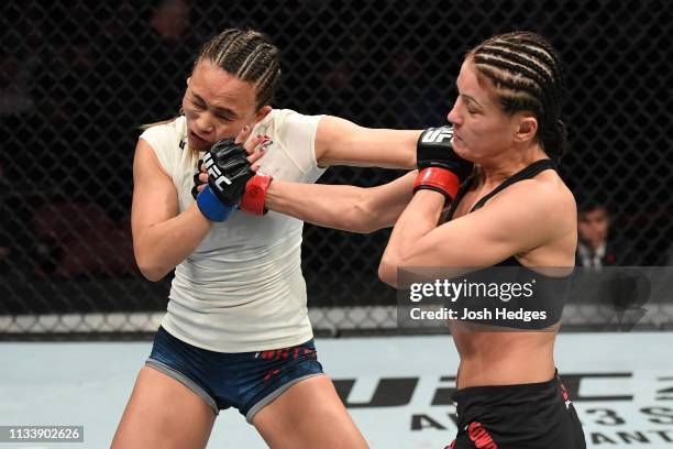 Karolina Kowalkiewicz of Poland punches Michelle Waterson in their women's strawweight bout during the UFC Fight Night Event event at Wells Fargo...