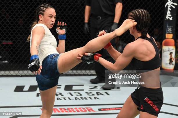 Michelle Waterson kicks Karolina Kowalkiewicz of Poland in their women's strawweight bout during the UFC Fight Night Event event at Wells Fargo...