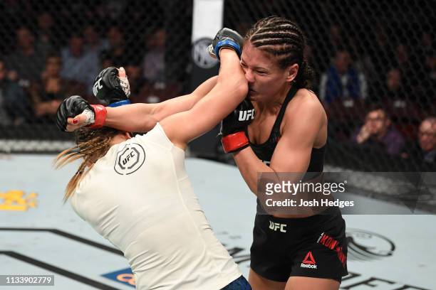Michelle Waterson punches Karolina Kowalkiewicz of Poland in their women's strawweight bout during the UFC Fight Night Event event at Wells Fargo...