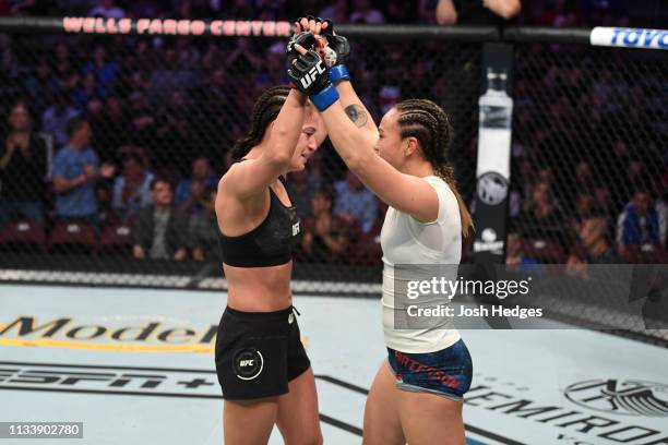 Karolina Kowalkiewicz of Poland and Michelle Waterson embrace after finishing three rounds in their women's strawweight bout during the UFC Fight...