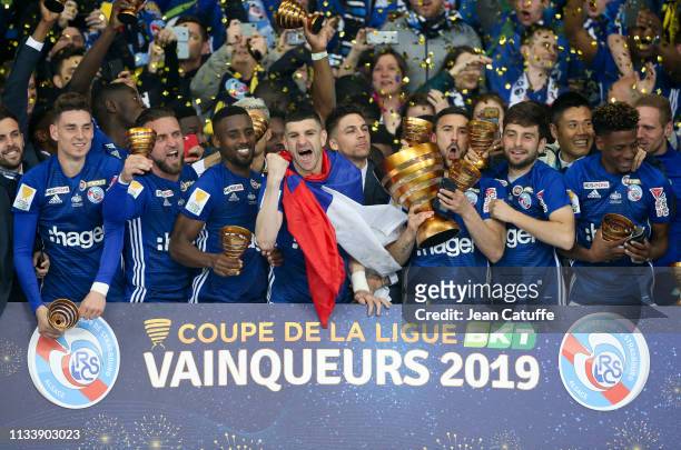 Captain Stefan Mitrovic, Pablo Martinez of Strasbourg and teammates celebrate the victory following the French League Cup final between Racing Club...
