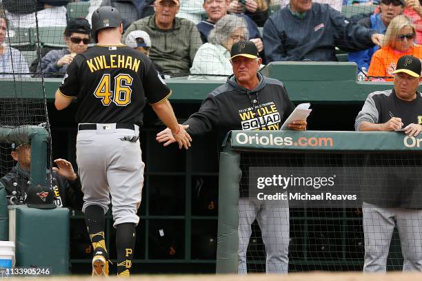 Patrick Kivlehan of the Pittsburgh Pirates celebrates with manager Clint Hurdle after scoring a run in the fifth inning against the Baltimore Orioles...