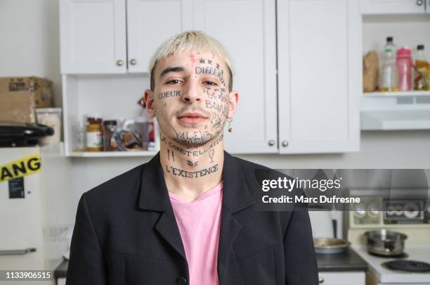 young tattooed man posing in his kitchen - body modification stock pictures, royalty-free photos & images