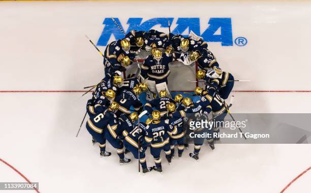 The Notre Dame Fighting Irish huddle around Cale Morris before the NCAA Division I Men's Ice Hockey Northeast Regional Championship final against the...