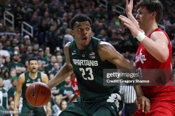 Xavier Tillman of the Michigan State Spartans looks to drive around Tanner Borchardt of the Nebraska Cornhuskers during the first half at Breslin...