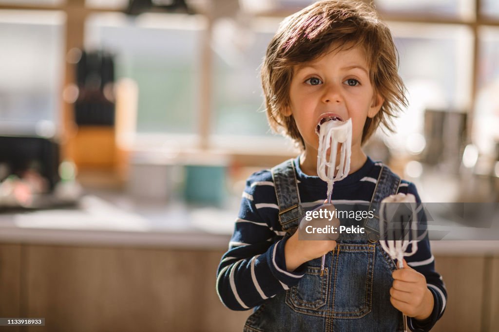 Cute Kid Tasting Whipped Cream of Egg Beater