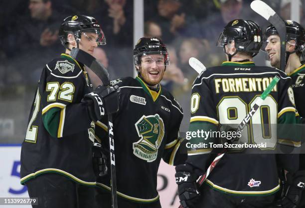 Kevin Hancock of the London Knights is congratulated after scoring a goal by Alec Regula and Alex Formenton and Evan Bouchard in the first period...