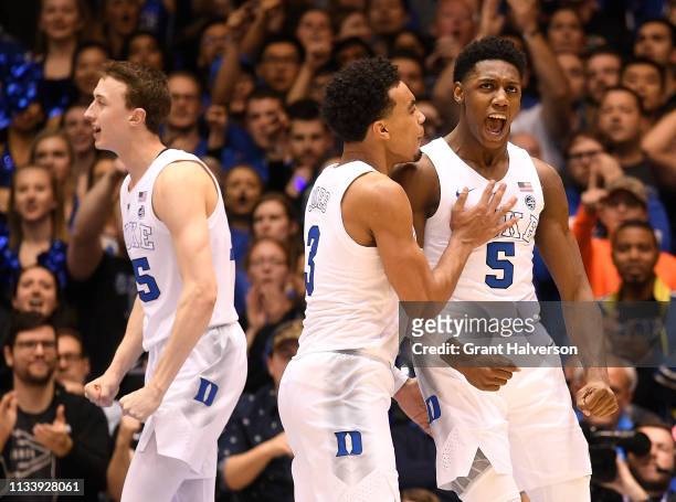 Alex O'Connell, Tre Jones and RJ Barrett of the Duke Blue Devils celebrate during the final seconds of their win against the Wake Forest Demon...