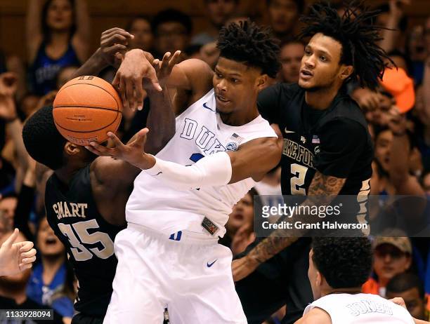 Cam Reddish of the Duke Blue Devils battles Ikenna Smart and Sharone Wright Jr. #2 of the Wake Forest Demon Deacons for a rebound during the second...