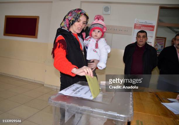 Voter casts her ballot with her baby at a polling station during local elections in Mus, Turkey on March 31, 2019. Polling in Turkeys local elections...
