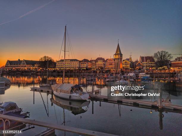 winter sunset over a harbor on lake constance - fall bike boat stock pictures, royalty-free photos & images