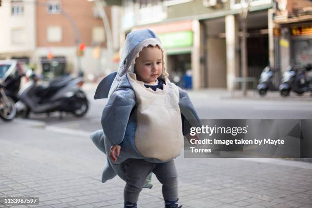 toddler dressed as a shark in the street - baby shark stock pictures, royalty-free photos & images
