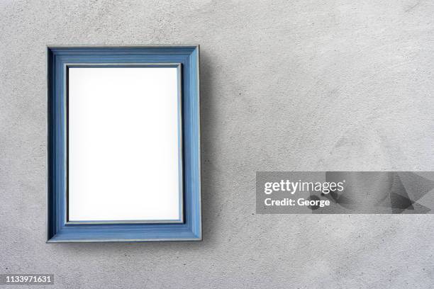 empty picture frames hanging on cement wall - frame on wall stock pictures, royalty-free photos & images