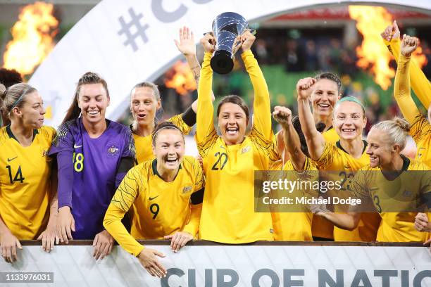 Sam Kerr of the Matildas lifts up the trophy and celebrates the win with teammates during the Cup of Nations match between Australia and Argentina at...