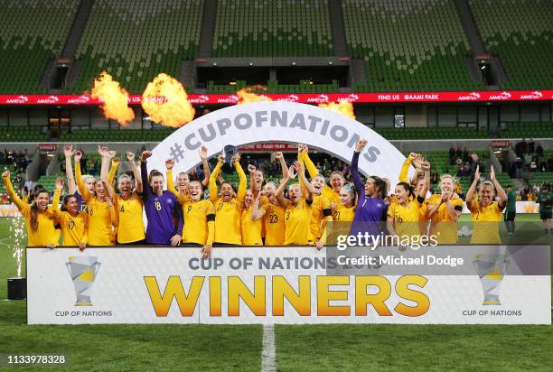 Sam Kerr of the Matildas lifts up the trophy and celebrates the win with teammates during the Cup of Nations match between Australia and Argentina at...