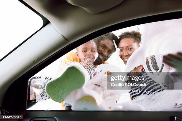 family washing their car - car splashing water on people stock pictures, royalty-free photos & images