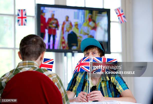 Boys hold British flags during a public viewing of the royal wedding of Britain's Prince William and Kate Middleton in the Charlottenburg castle in...