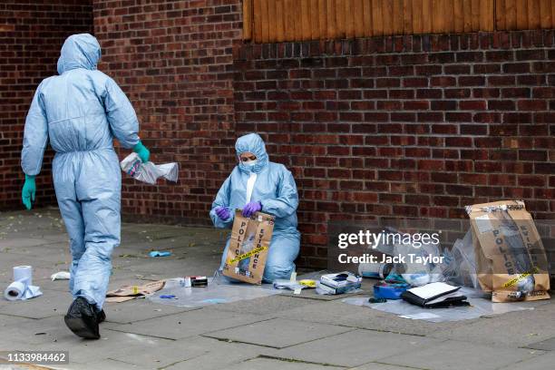 Forensics teams work at the scene of a stabbing in Edmonton on March 31, 2019 in London, England. Four people have been stabbed in a spate of knife...