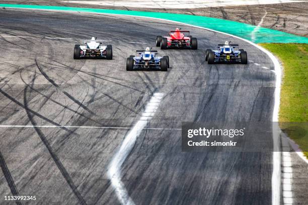 men driving formula racing cars - rw racing gp stock pictures, royalty-free photos & images