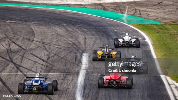 men driving formula racing cars - motorsport grand prix stock pictures, royalty-free photos & images